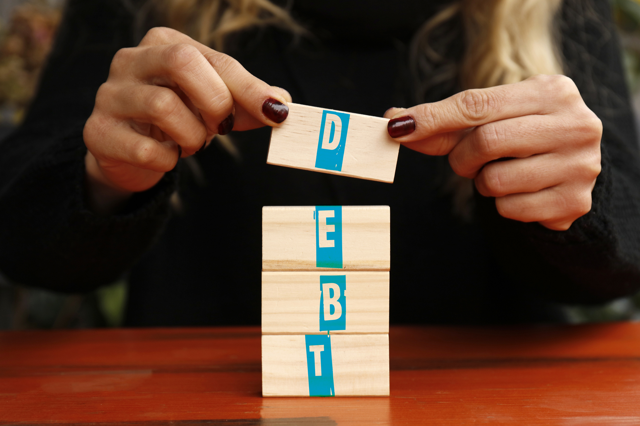 Blocks of wood spelling out debt